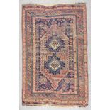 A Late 19th Century Afshar Rug, woven in colours of fawn, navy blue and wine, with a bold central