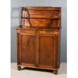 A Regency Mahogany Chiffonier, the upper part fitted two open shelves on scroll supports, the base