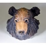 A Japanese Carved and Stained Wood Bear's Head, signed, 12ins (30.5cm) high