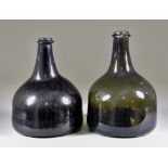 An English Glass Mallet-Shaped Wine Bottle of Olive Tint, Early 18th Century, 7.5ins high, and