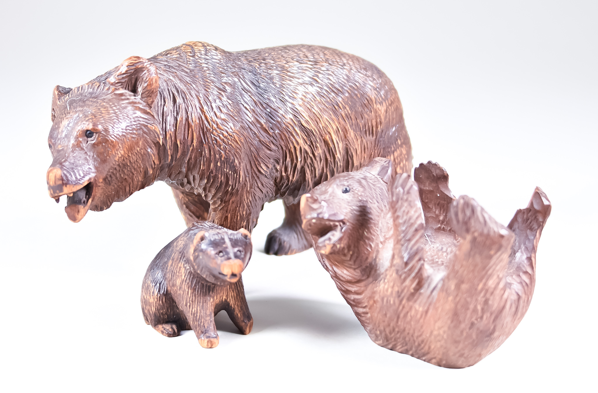 Three Black Forest Carved Wood Models of Bears - a walking bear, 4.25ins high, a bear lying on its