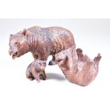 Three Black Forest Carved Wood Models of Bears - a walking bear, 4.25ins high, a bear lying on its