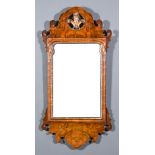A Walnut Wall Mirror of Georgian Design, the shaped and fretted cresting with gilt Prince of Wales
