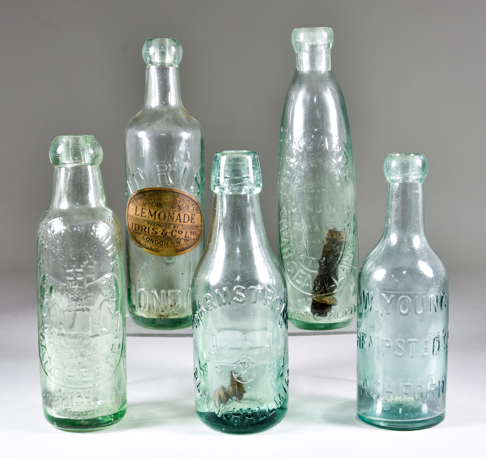 A Collection of English Glass Soda Water, Lemonade and Ginger Beer Bottles, of primarily pale