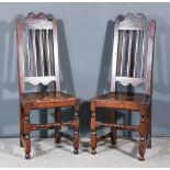 A Pair of 18th Century Oak and Elm High Back Hall Chairs, with shaped crest rails, moulded rails