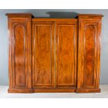An Edwardian Mahogany Breakfront and Drop-Centre Wardrobe, inlaid with satinwood bandings and