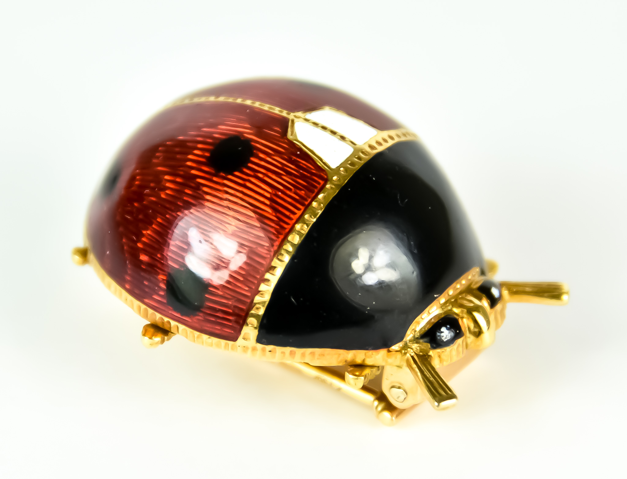 An 18ct Gold and Enamel Ladybird Brooch, Modern, with enamel on engine turned body, 28mm x 24mm