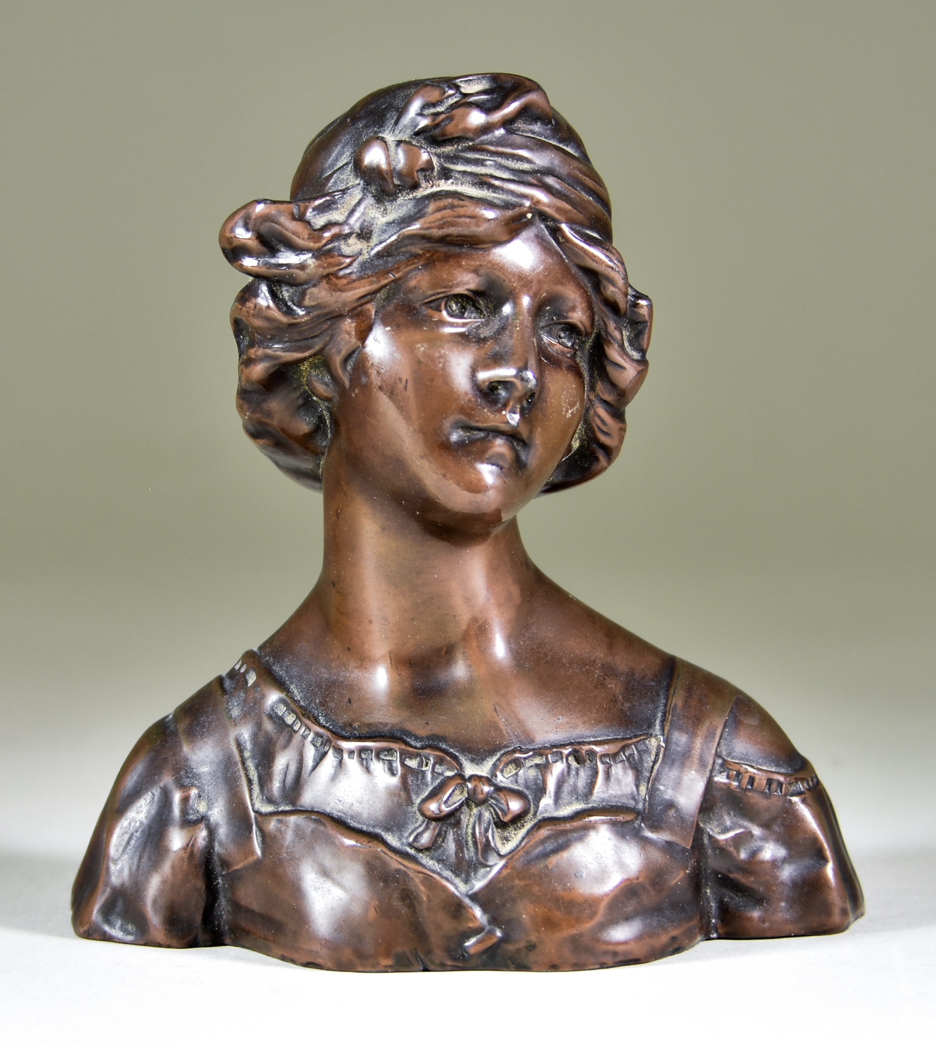 Gustave Van Vaerenbergh (1873-1927) - Bronzed metal bust - young lady with elaborately dressed hair,