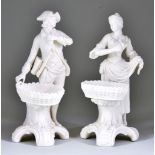 A Pair of Minton Parian Sweetmeat Figures, 1853, both with baskets and wearing 18th Century dress,