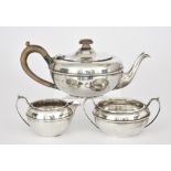 A George V Silver Circular Three-Piece Tea Service, by William Comyns & Sons Ltd., London, 1931,of