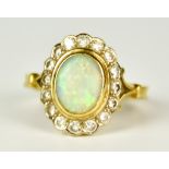 A 9ct Gold and Platinum Opal and Diamond Ring, 20th Century, set with a centre opal, 6mm x 8mm,