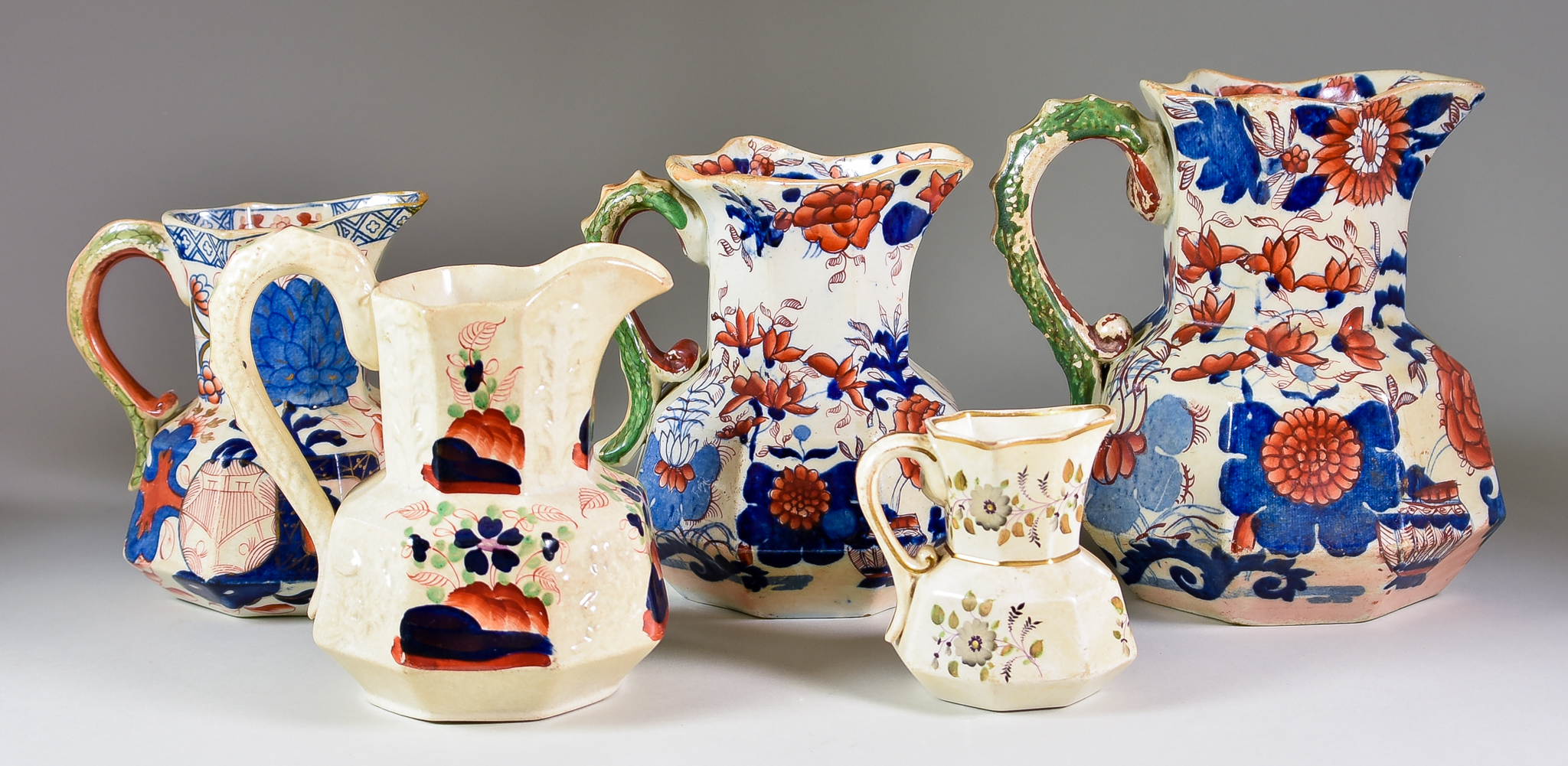 Eleven Ironstone Jugs - including Masons with Imari pattern in blue and red, 7ins high, another