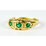 A Three Stone Emerald Ring, Modern, 18ct yellow gold set with three small emerald stones,