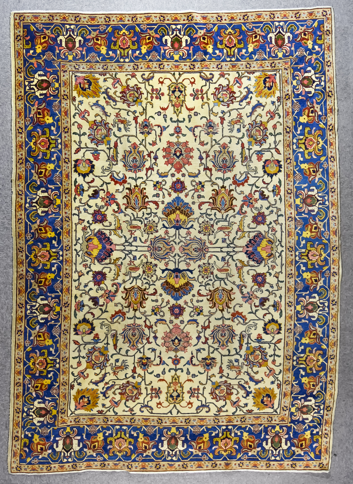 A Late 19th Century Tabriz Carpet, woven in colours of ivory, navy blue and rose, the field filled