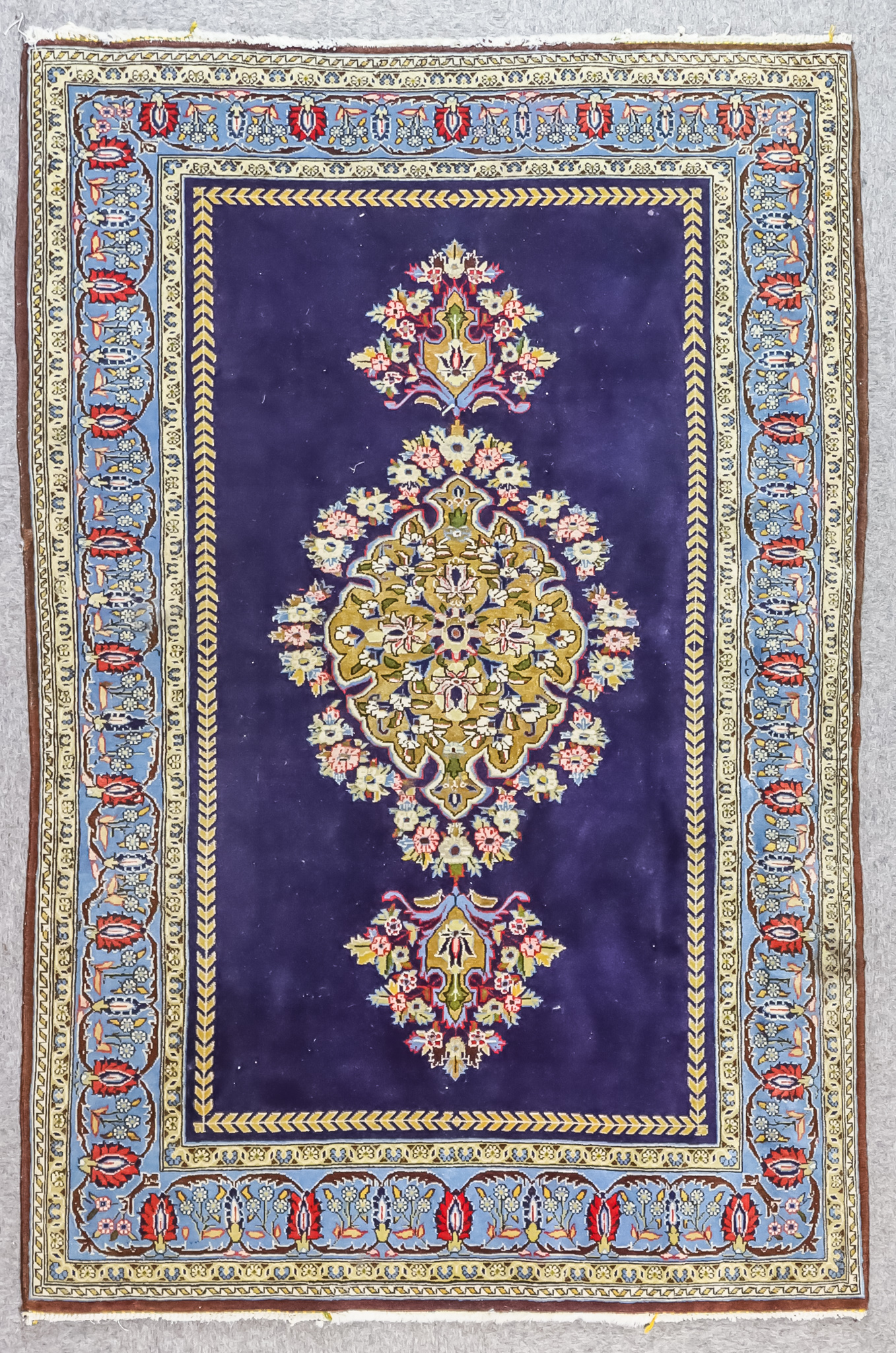 An Early 20th Century Part Silk Qum Rug woven in colours of ivory, navy blue and pale blue with a