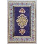 An Early 20th Century Part Silk Qum Rug woven in colours of ivory, navy blue and pale blue with a