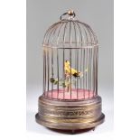 A Continental Brass Automaton Singing Bird in a Cage, Late 19th/Early 20th Century, with clockwork