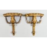 A Pair of Giltwood Wall Brackets of Baroque Design, hung with bellflower, 13ins x 7.5ins x 14.