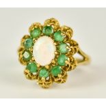 A 9ct Gold Emerald and Opal Ring, 20th Century, set with a centre opal, 6mm x 7mm, surrounded by ten