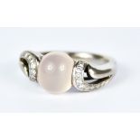 An 18ct White Gold Rose Quartz and Diamond Ring, Modern, set with a centre cabochon rose quartz