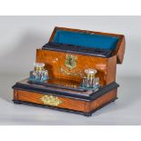 An Edwardian Oak Stationery and Ink Stand, with two glass inkwells and a frieze drawer, 12ins x 9.