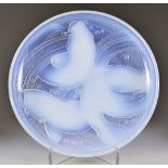 A French Opalescent Glass Dish, 20th Century, moulded with three swimming fish, 12ins diameter