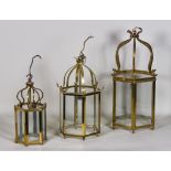 Three Polished Brass and Glass Hexagonal Hall Lanterns, one with ribbon and reeded mounts, 11.5ins