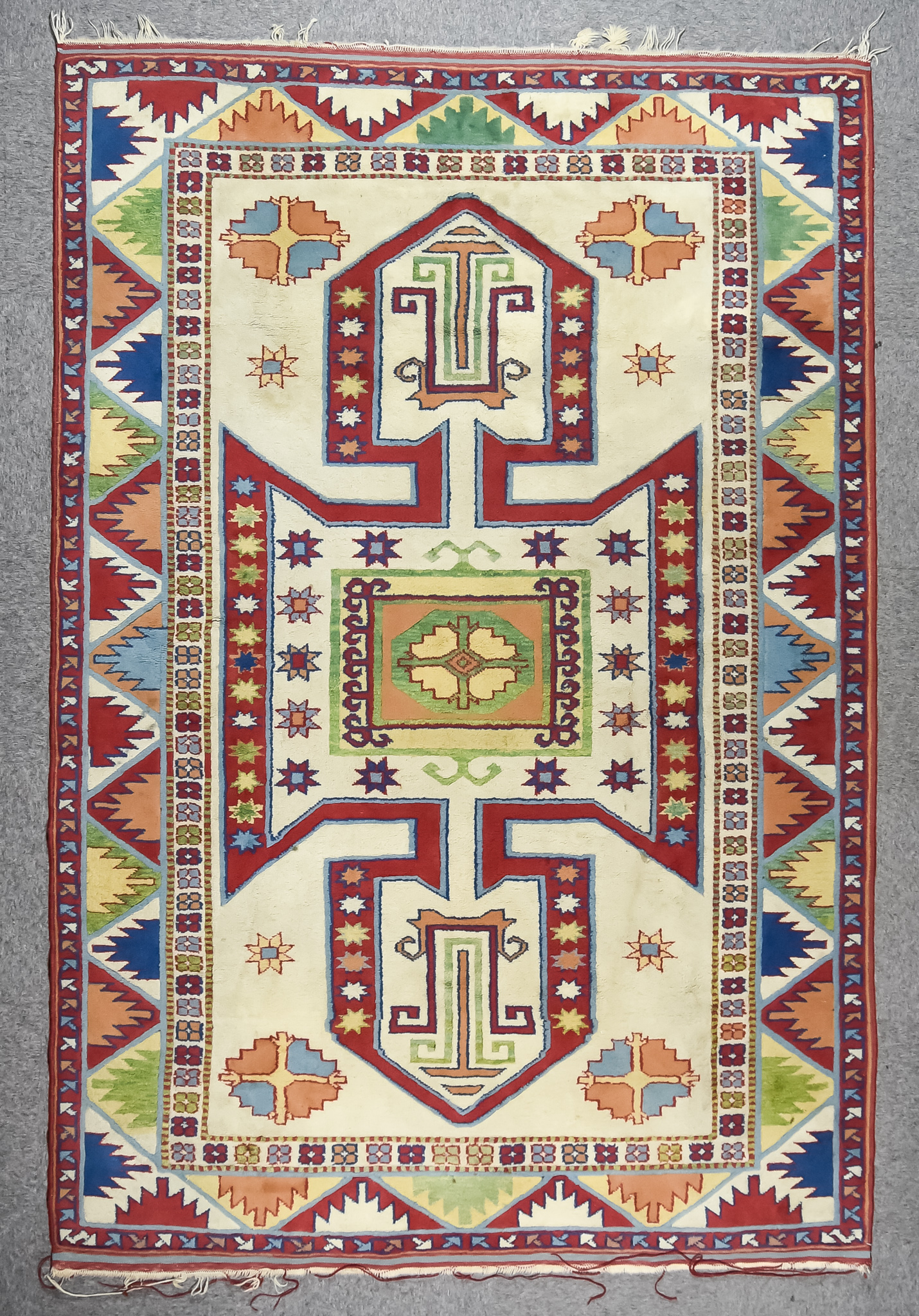 An Anatolian Carpet of "Kazak" Design, woven in pastel shades with a central pole medallion, the