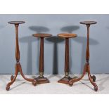 Two Pairs of Mahogany Circular Torcheres, one pair with shaped rims, on slender hexagonal baluster