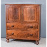 A Late Georgian Mahogany Millinery Cabinet, enclosed by a pair of panelled doors, fitted two drawers