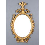 A Gilt Framed Oval Wall Mirror, with Prince of Wales feathers cresting, the frame with floral and