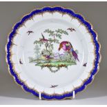 A Worcester Dessert Plate, Circa 1775-78, of scalloped shape, with underglaze blue border, enamelled