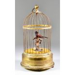 A Continental Brass Automaton Singing Bird in Cage, Late 19th/Early 20th Century, with clockwork