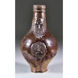 A German Brown Salt Glazed Bartmannskrug, 17th Century, with applied bearded mask and oval seal,