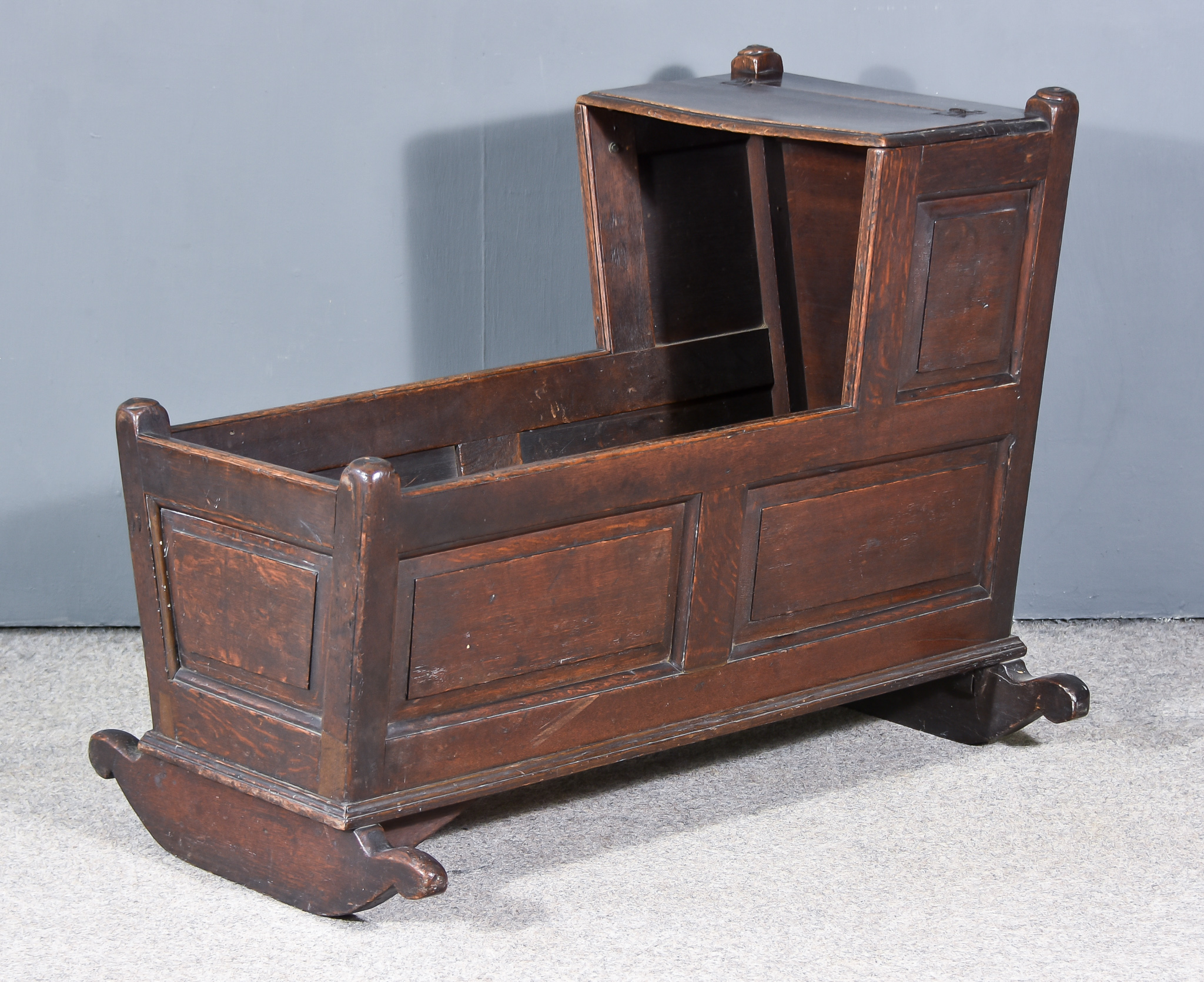 An Old Panelled Oak Crib with Rising Canopy and Tapered Sides on Rocker , 21ins x 36ins x 28ins