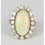 An 18ct White Gold Opal and Diamond Ring, Modern, set with a centre opal, 18mm x 14mm, surrounded by