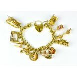 An 18ct Gold Charm Bracelet, 20th Century, suspended with eleven charms, various gold carats,