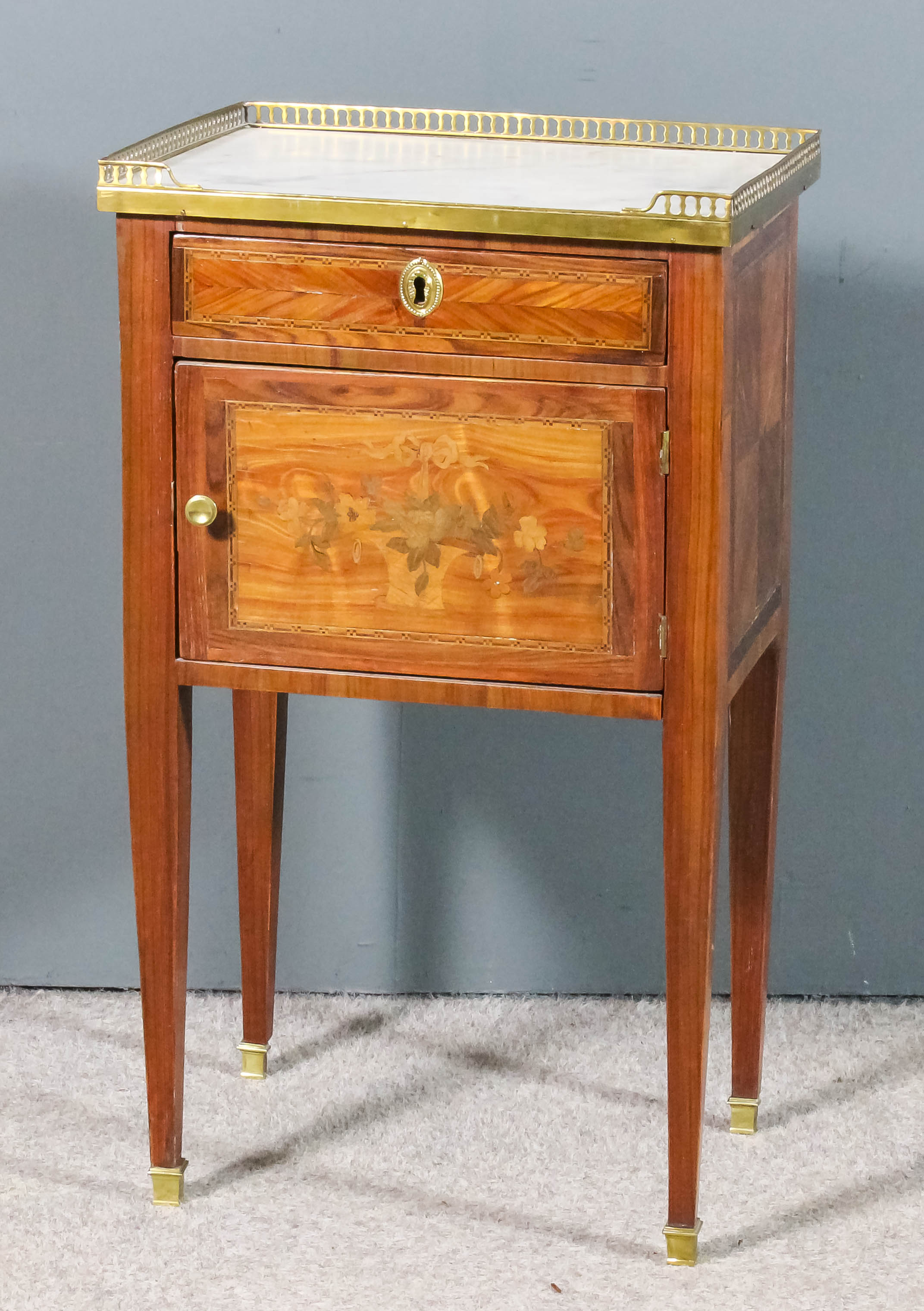 A French Kingwood and Marquetry Rectangular Bedside Cabinet, the white veined marble top with gilt