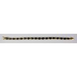 A Sapphire Line Bracelet, Modern, 14ct gold, set with eighteen faceted sapphires, approximately
