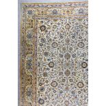 An Early 20th Century Kirman Carpet, woven in pastel shades of navy blue, pale blue and fawn, with