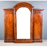 A Victorian Mahogany Break Front Wardrobe, the moulded cornice with arched cresting, the centre