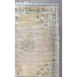 A Modern Part-Silk Carpet of Chinese Design, woven in pastel shades with a central medallion made up