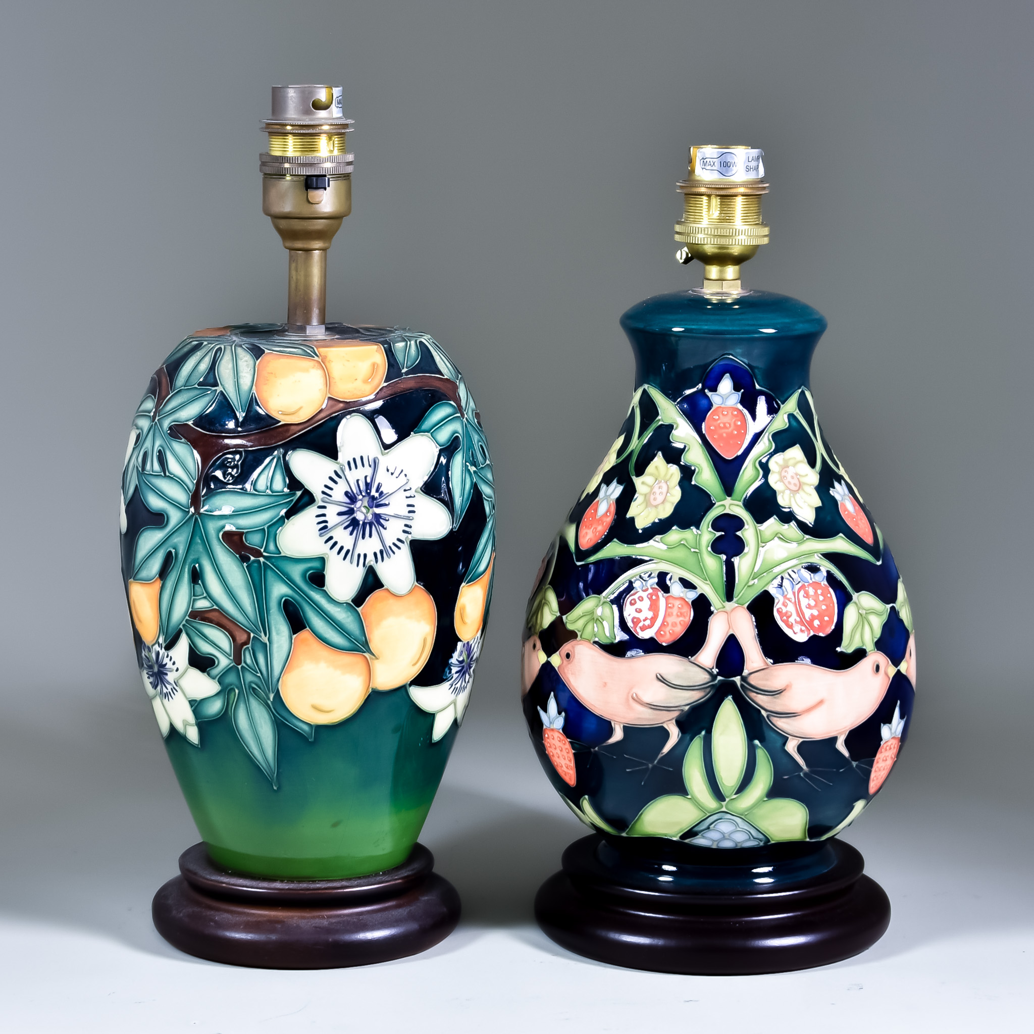 Two Moorcroft Pottery Table Lamps on Wooden Bases, one decorated in Passion Fruit design, 8ins