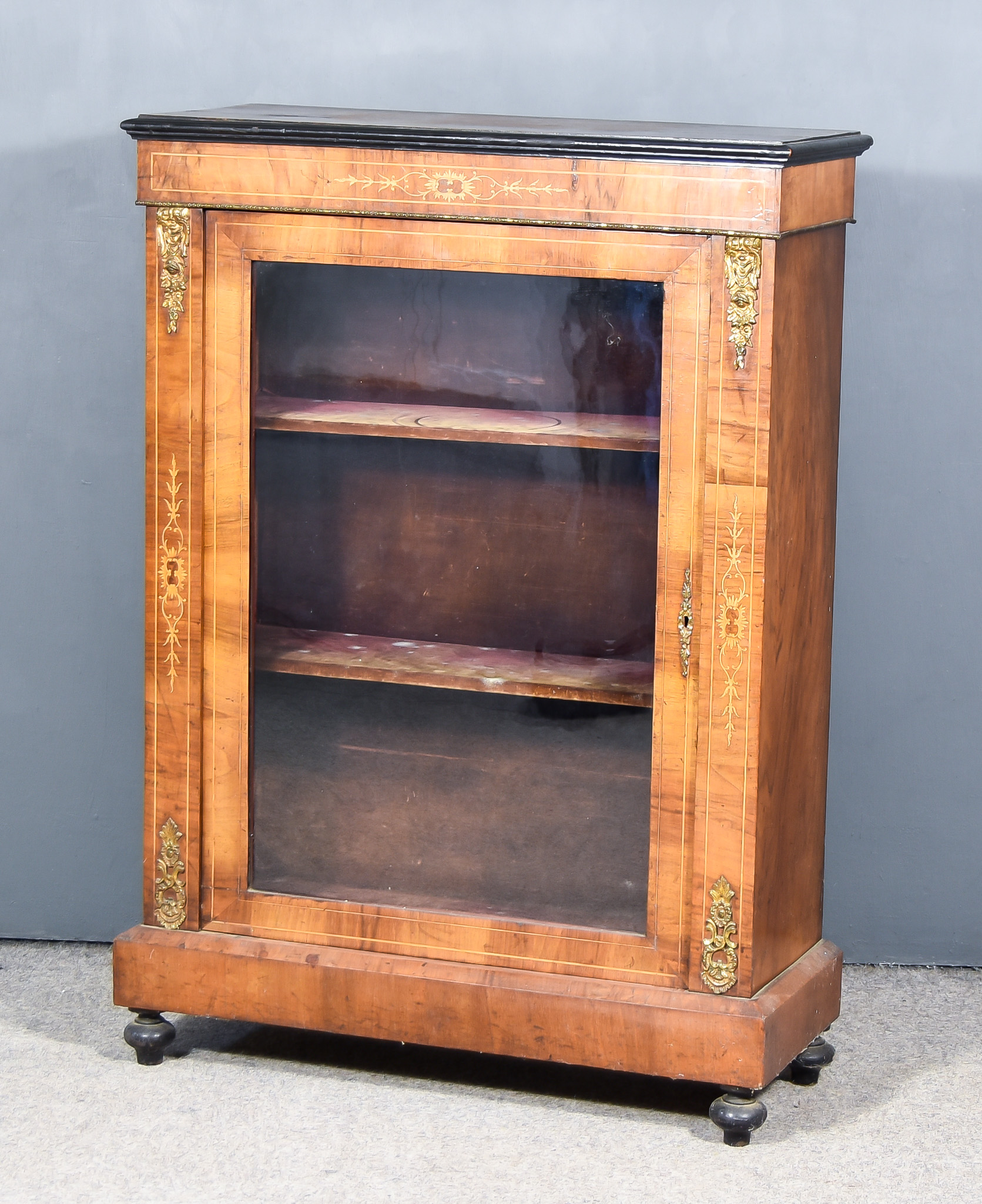 A Late Victorian Walnut and Gilt Metal Mounted Dwarf Display Cabinet, with ebonised moulded edge