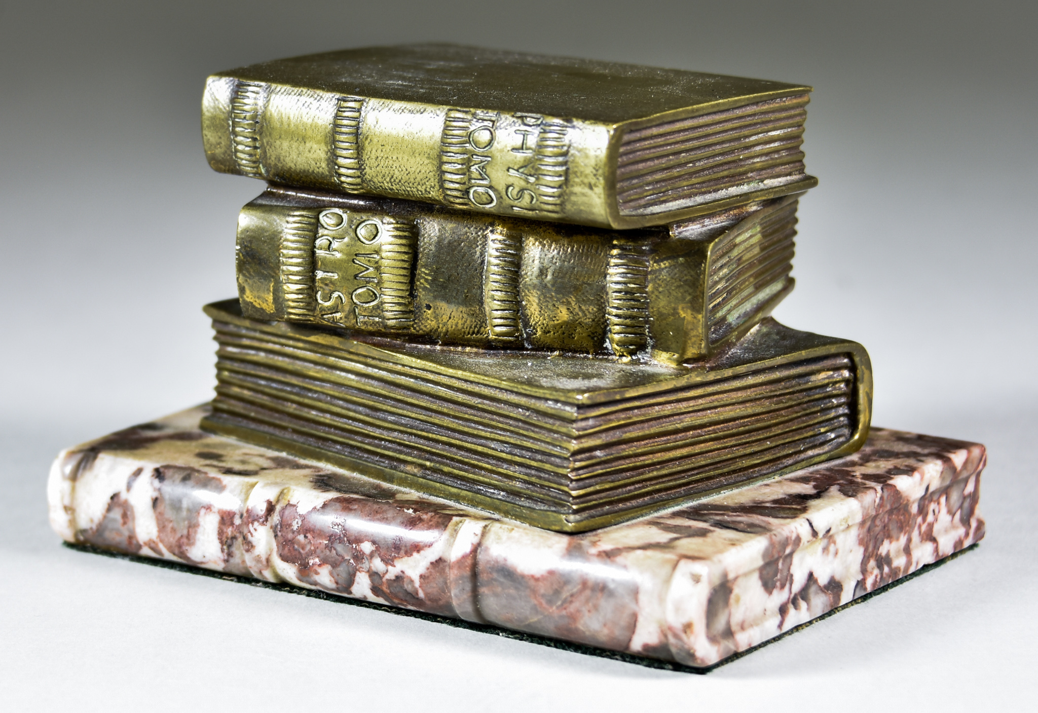 A Bronze Desk Paperweight Modelled as Three Stacked Books, 19th/20th Century, on a polished marble