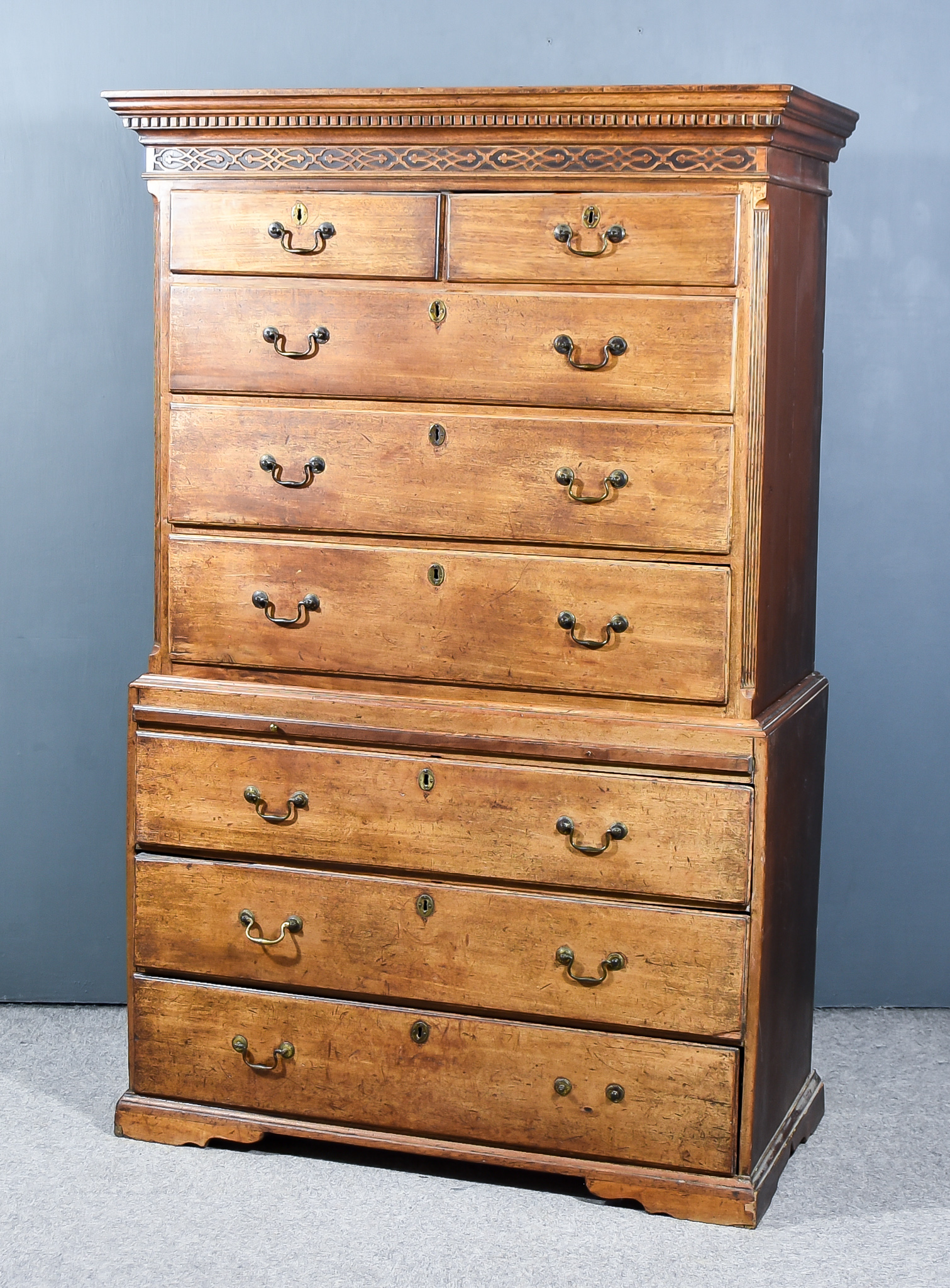 A George III Mahogany and Pine Sided Tallboy, the upper part with moulded dentil cornice and blind
