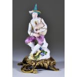A Meissen Figure, Circa 1745, of the seated Harlequin with bagpipes, modelled by J J Kaendler, 6.