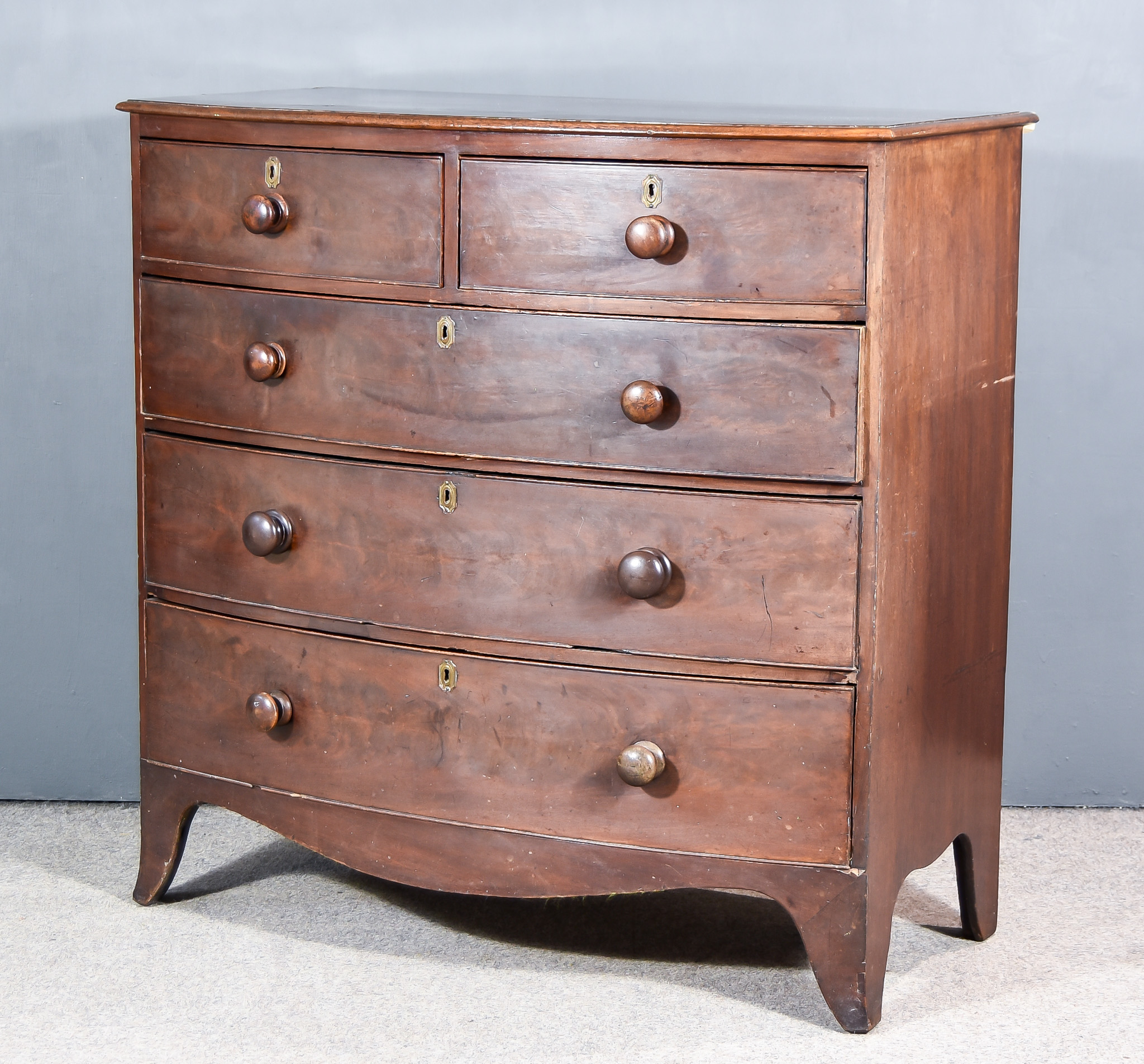 A George III Bowfront Mahogany Chest, with moulded edge to top, fitted two short and three long