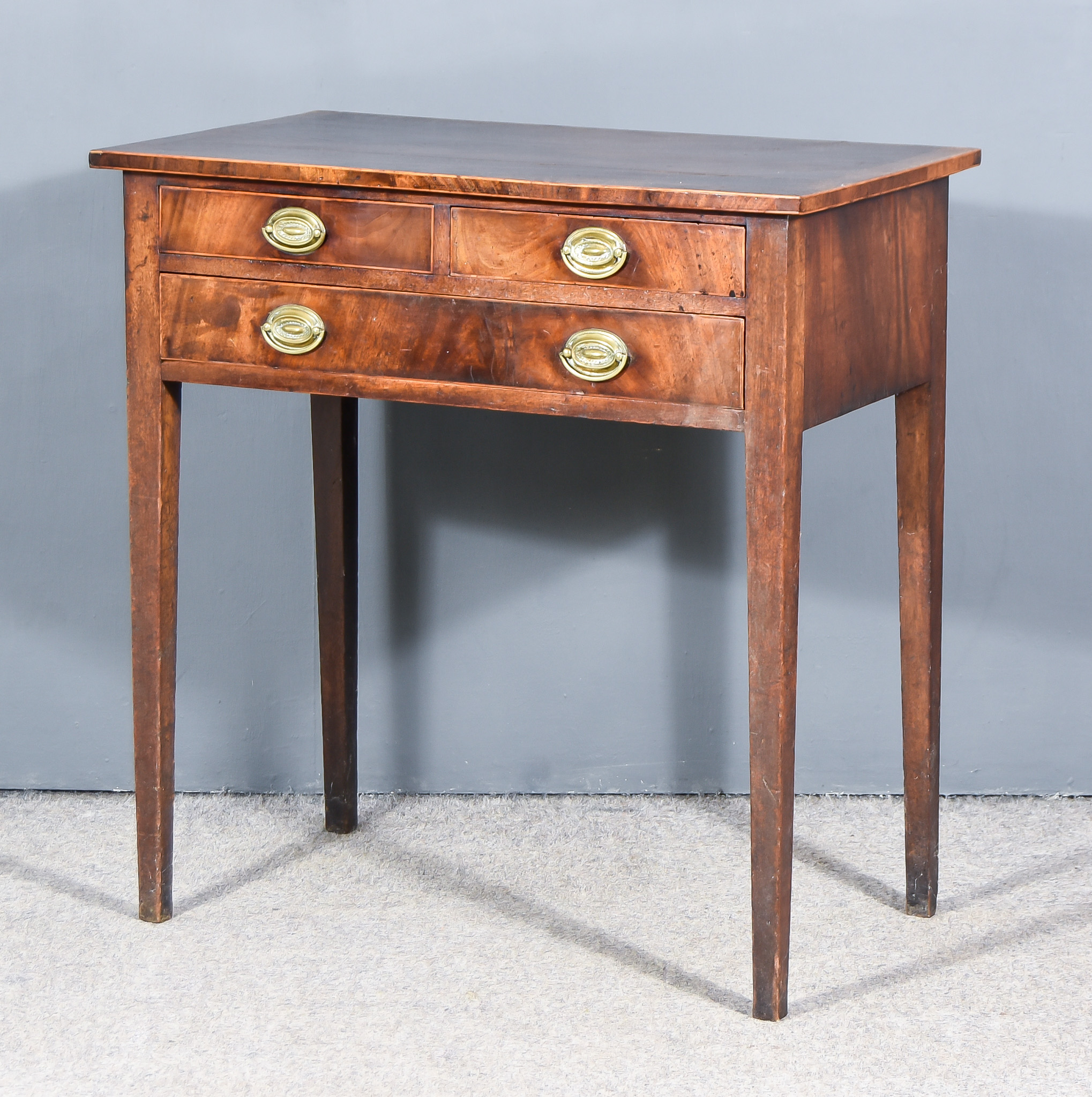 A George III Mahogany Rectangular Side Table, with cross banded top, fitted two short and one long