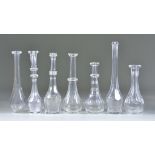 Seven Glass Toddy Lifters, 19th Century, including - one plain toddy lifter 7ins high, four with